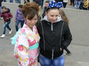 Odessa, Ukraine - Asian performer posing with Ukrainian woman