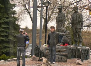 Ukraine, Kiev - two friends at a war memorial
