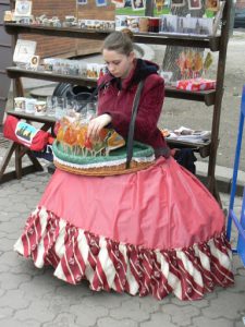 Ukraine, Lviv - central city:  girl selling animal-shaped lollypops