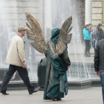 Ukraine, Lviv - central city:  angel costumed photo model (tourists pay