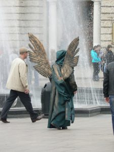 Ukraine, Lviv - central city:  angel costumed photo model (tourists pay
