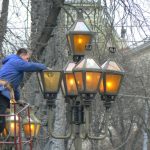 Ukraine, Lviv - central city: replacing lamp bulbs