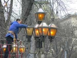Ukraine, Lviv - central city: replacing lamp bulbs
