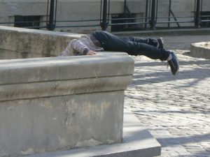 Ukraine, Lviv - boy fetching coins out of a fountain