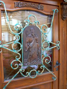 Ornate door with carving of Poisedon