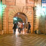 Young people entering old town for a disco