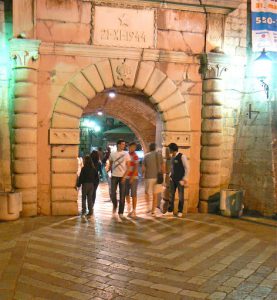 Young people entering old town for a disco