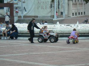 Montenegro, Podgorica: central plaza fountain and kiddie go-carts