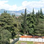 Montenegro, Podgorica: mountains beyond the city; in foreground is ground-breaking