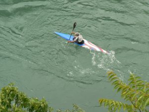 Bosnia-Herzegovina, Mostar City: kayaker begotiating the fast-flowing Neretva River