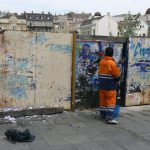 Serbia, Belgrade: worker removing postings