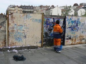 Serbia, Belgrade: worker removing postings
