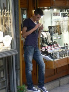Macedonia, Skopje: checking his phone in the Carsija