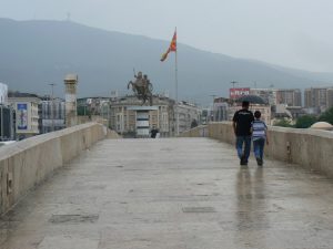 Macedonia, Skopje: walking over the old stone bridge toward Macedonia
