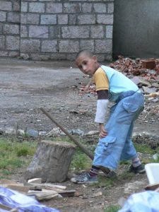 Macedonia, Lake Ohrid: boy chopping wood