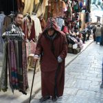 Old man plodding his way along a souq,