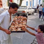 Tunisia, Sidi Bou Said. Boy Buying a pastry  (photo by