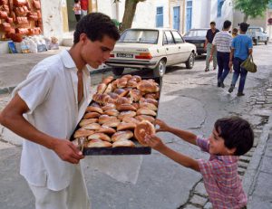 Tunisia, Sidi Bou Said. Boy Buying a pastry  (photo by