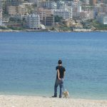 Albania, Saranda city - dog walks man