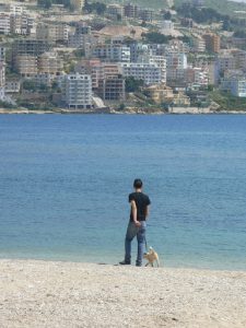 Albania, Saranda city - dog walks man