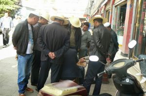 Tibet, Lhasa: buyers gather around a fungi seller