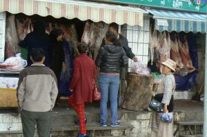 Tibet, Lhasa: women dressed in different attire  shopping at a