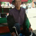 Tibet, Lhasa: a cheerful bicycle rickshaw driver