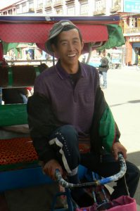 Tibet, Lhasa: a cheerful bicycle rickshaw driver