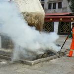 Tibet: Lhasa - street sweeper tending incense ashes