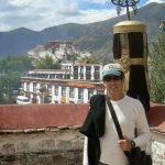 Tibet: Lhasa - Michael atop the Jarkang Temple with Potala Palace