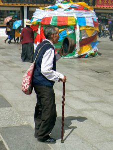 Tibet: Lhasa - elderly man in Barkhor Square