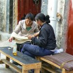 Tibet: Lhasa - women winding fabric strands