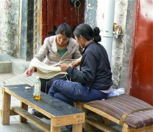 Tibet: Lhasa - women winding fabric strands