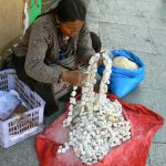 Tibet: Lhasa - vendor selling butter squares
