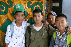 Tibet: Lhasa - young boys visiting a temple