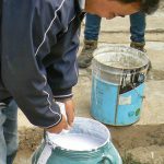 Tibet: Lhasa - adding milk to white paint to color