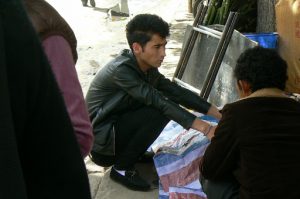 Tibet: Lhasa - young man in the market