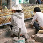 Tibet: Lhasa - metalworkers applying paint  to a decorative awning