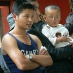 Tibet: Lhasa - young man observing debate