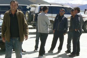 Tibet: tourist car drivers at a pit stop