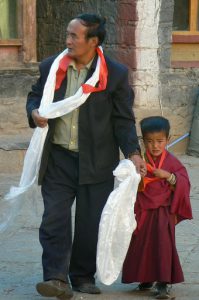 Tibet: young monk with his father