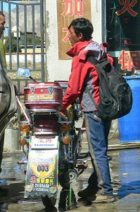 Tibet: Man with motorbike