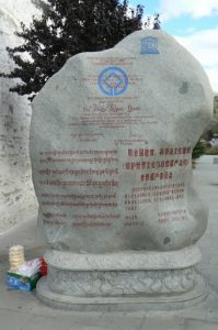 Tibet: Lhasa - carved rock in Tibetan, Chinese and English describing