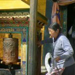 Tibet: Lhasa - Potala Palace - pilgrims and prayer wheels