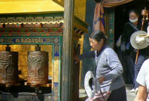 Tibet: Lhasa - Potala Palace - pilgrims and prayer wheels