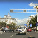 Tibet: Lhasa - entering downtown with Hotel international in background.