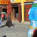 Tibet: Lhasa - Tibetan Quarter of the city; pilgrims walking