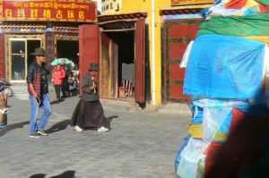 Tibet: Lhasa - Tibetan Quarter of the city; pilgrims walking