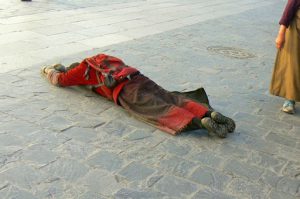 Tibet: Lhasa - Tibetan Quarter of the city;  pilgrim prostrating