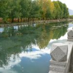 Tibet: Lhasa - Tibetan quarter; a canal surrounds a park.